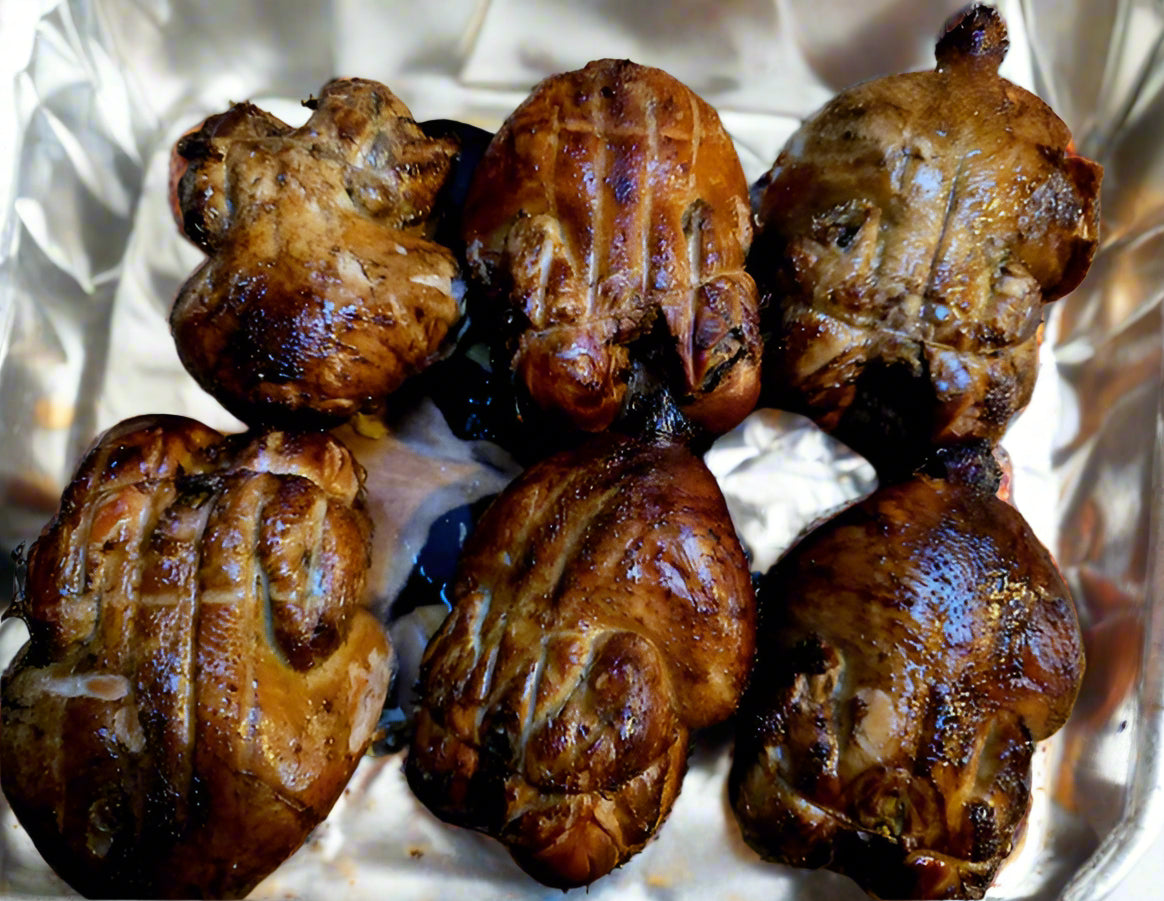 Roasted chicken meat on a foiled paper tray.